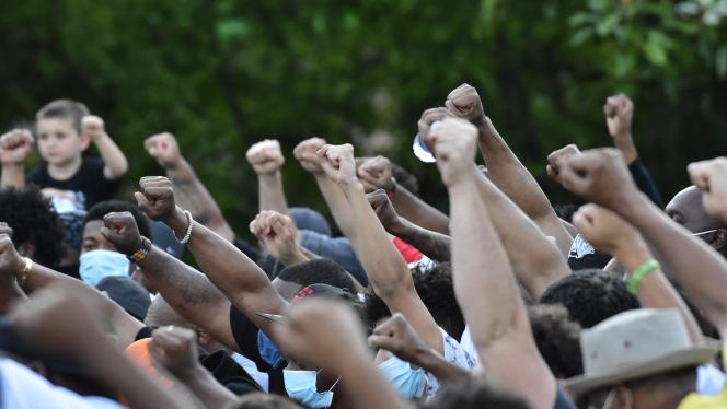 A group of protesters holding fists in the air