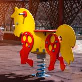 playground horse sits empty in the sun