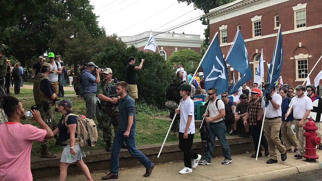 People carrying Identity Evropa flags march in Charlottesville, August 16, 2017