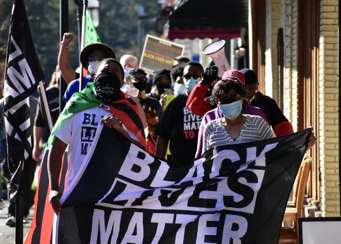 A group of people holding a Black Lives Matter banner