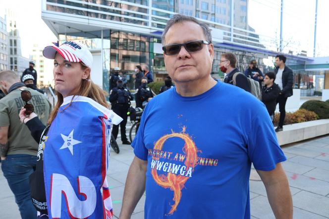 A trump supporter and a man wearing a QAnon T shirt
