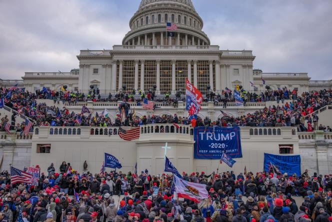 The Capitol building in D.C. with Trump supporters on it.