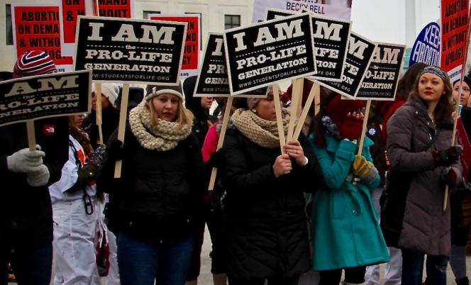 Protesters holding signs saying "I Am the Pro Life Generation."