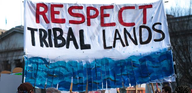 A protest sign that says "Respect Tribal Lands"