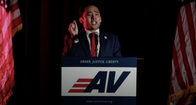 An asian man standing at a podium with the logo AV on the podium