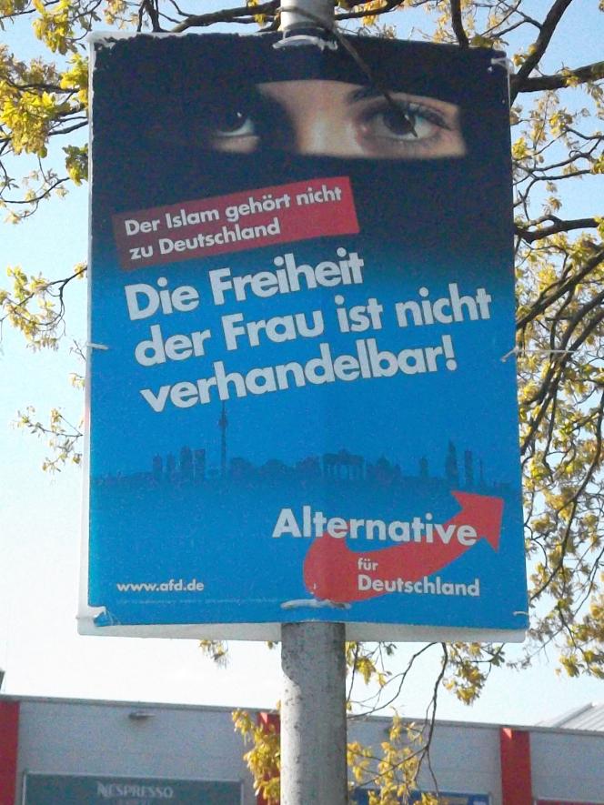 A woman's eyes under a burkha. The text under is in German, but reads "Islam does not belong to Germany. Women's freedom is not negotiable." 