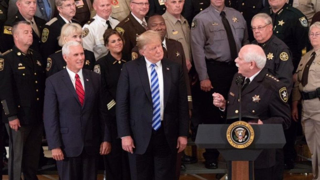 U.S President Donald Trump and Vice President Mike Pence look on as Sheriff Thomas Hodgson of Bristol County Massachusetts delivers remarks in the East Room of the White House September 5, 2018 in Washington, DC.