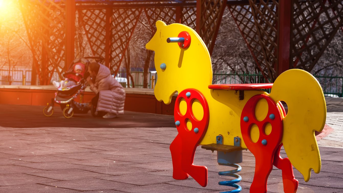 playground horse sits empty in the sun
