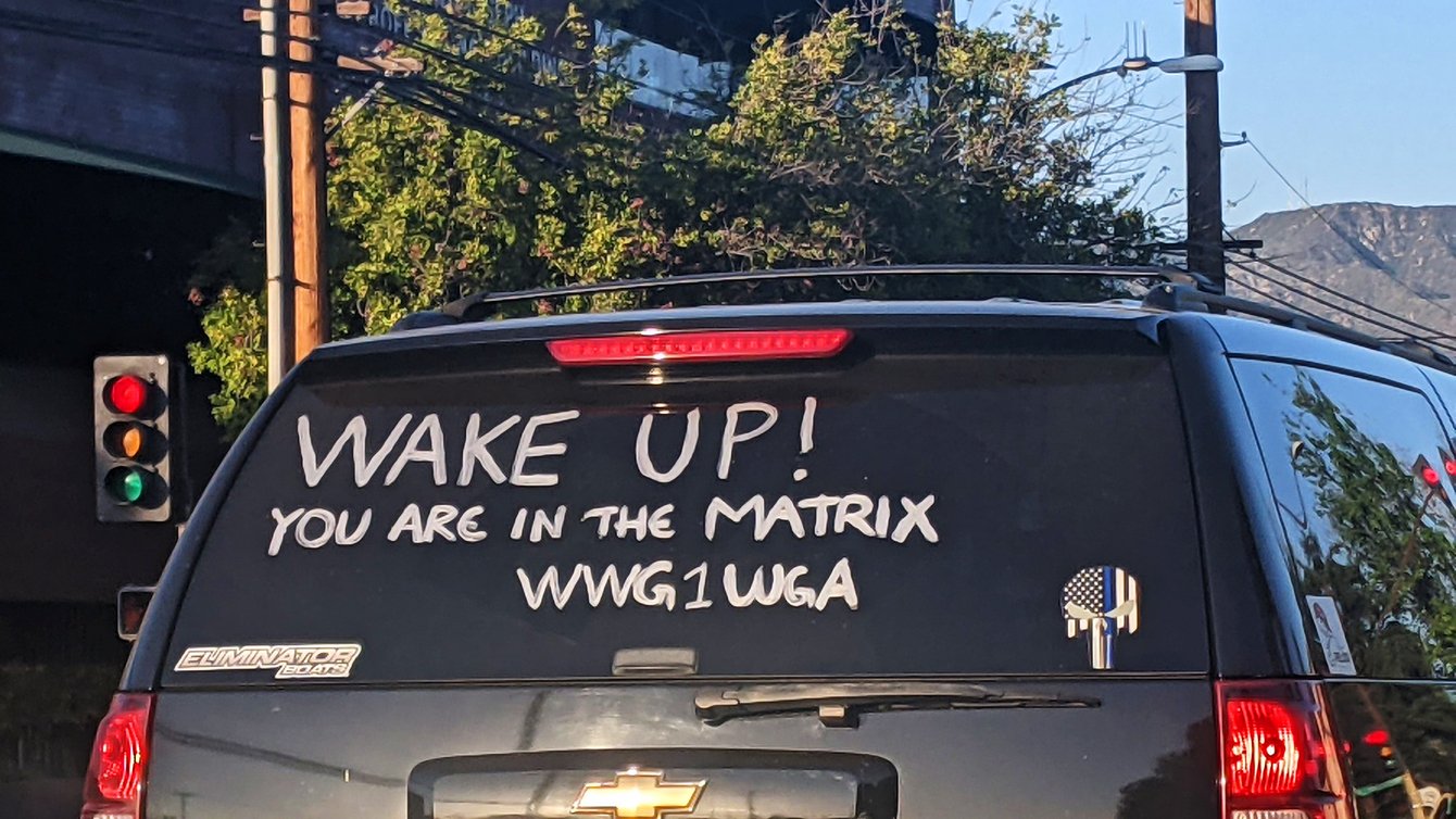 Writing on SUV rear window that reads "Wake Up! You are in the Matrix WWG1WGA"