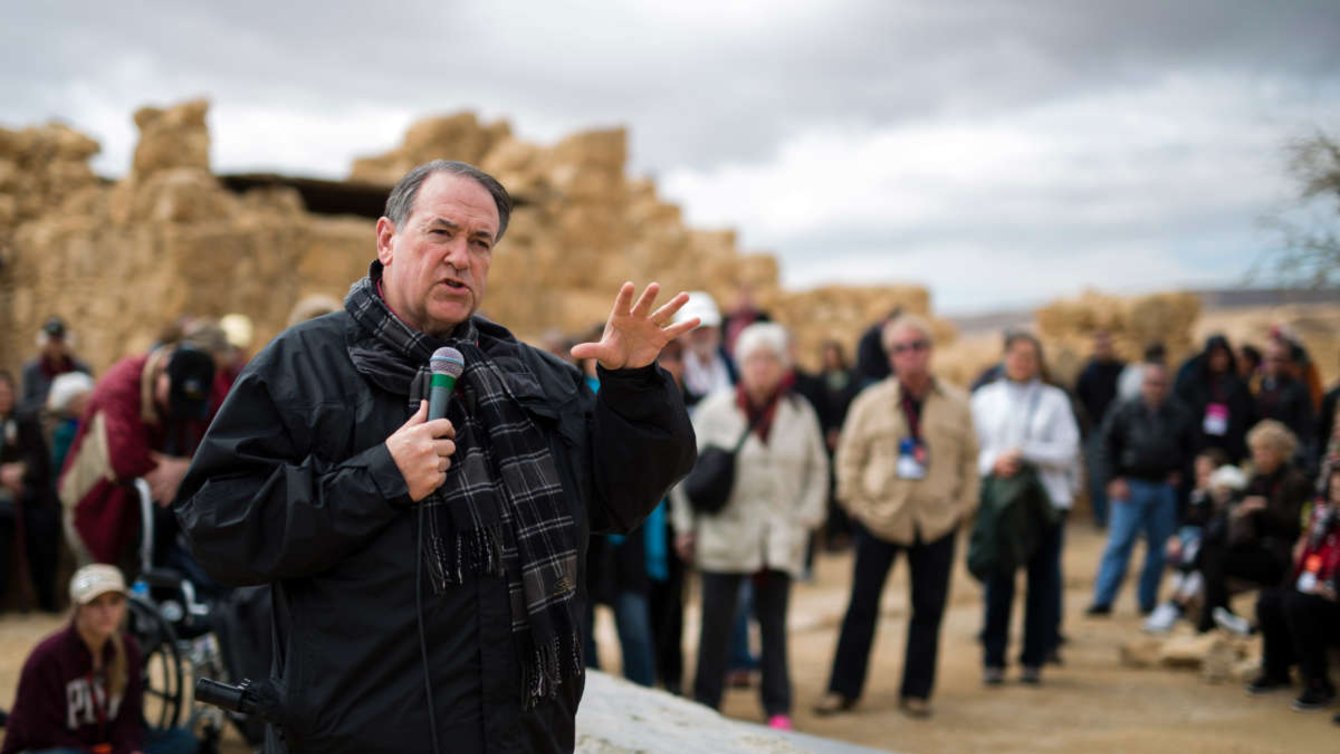 Man standing in front of crowd speaking into microphone