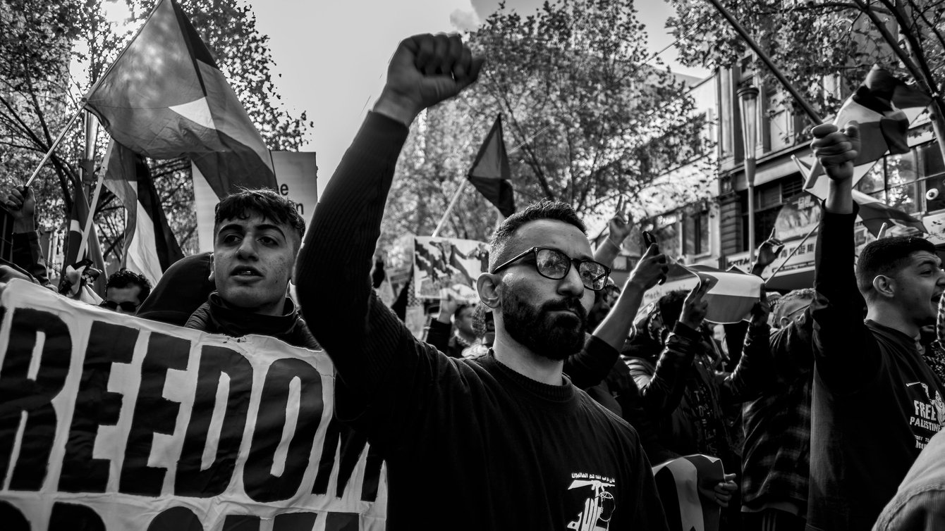 Black and white photo of protesters with raised fists