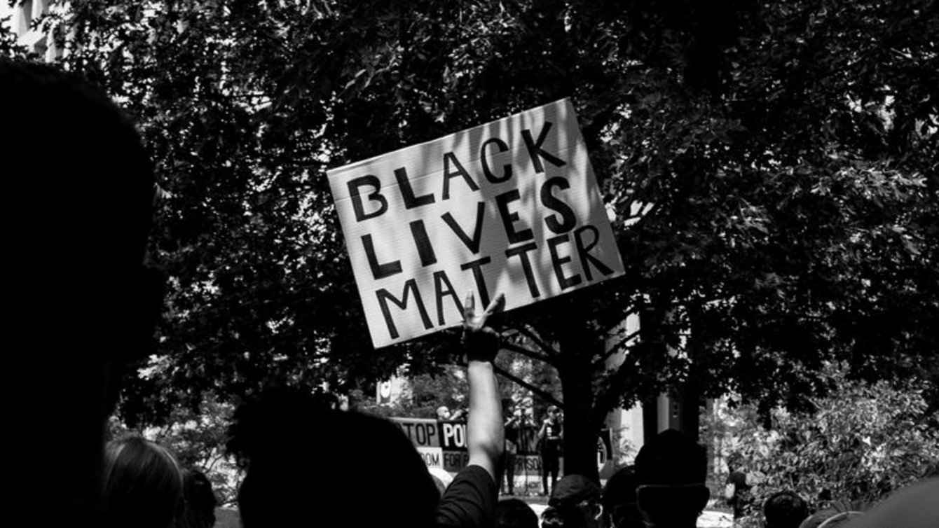 A protester holding a sign that says Black Lives Matter