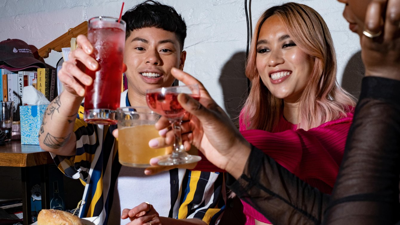 A group of friends of varying genders making a toast