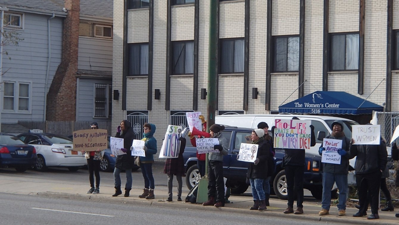 A group of people in Chicago holding protest signs