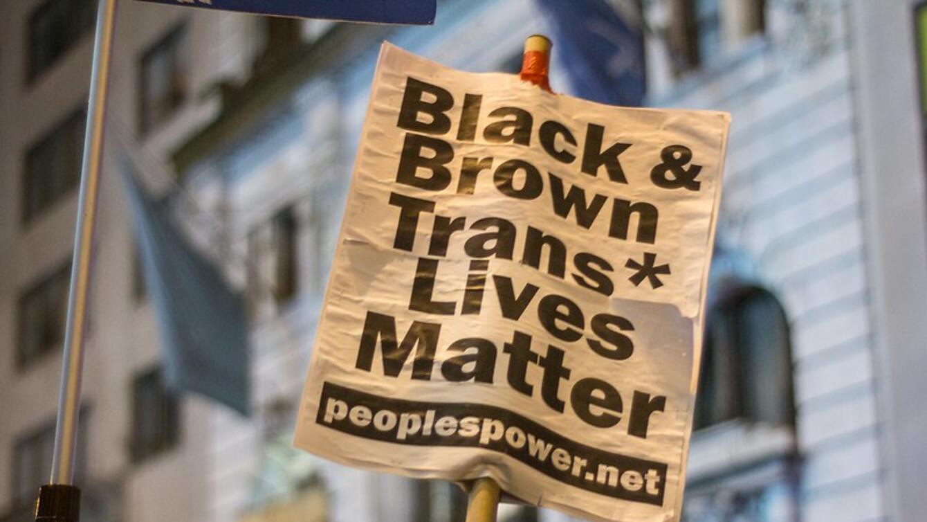 A sign that says "Black & Brown Trans Lives Matter."