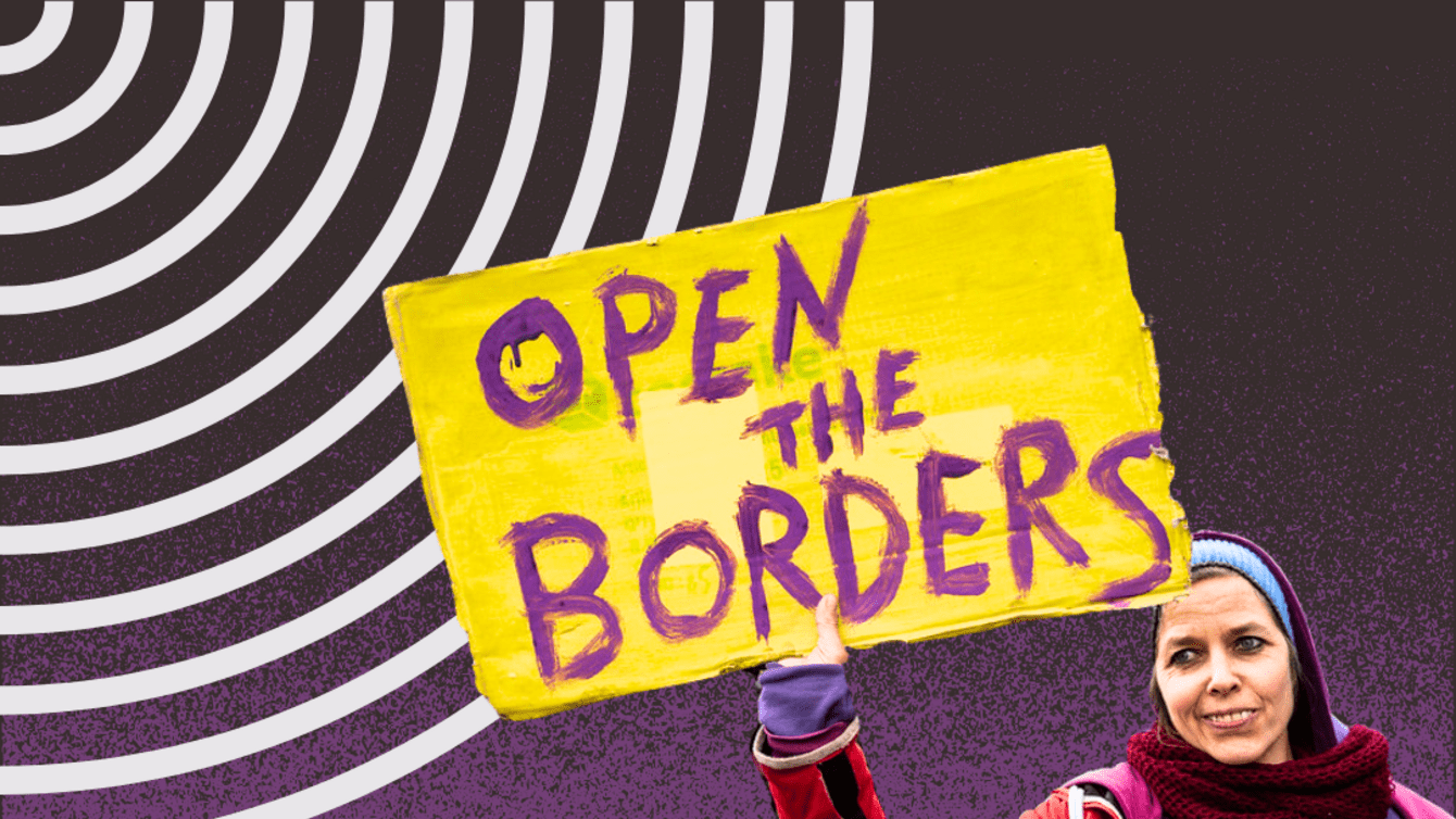 A woman holding a sign that says Open the Borders