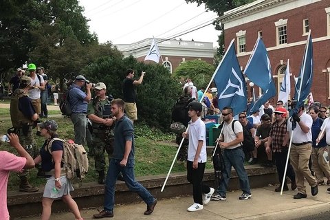 People carrying Identity Evropa flags march in Charlottesville, August 16, 2017