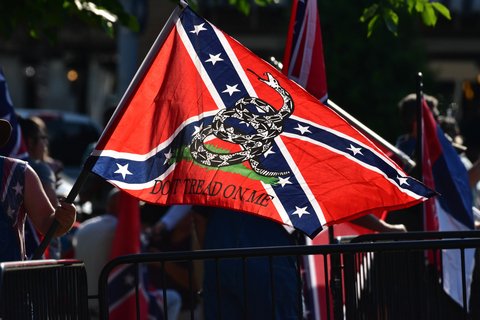 A confederate flag with a "don't tread on me" symbol on it.