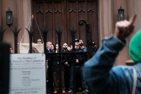 Abortion activists gather outside of the Basilica of St. Patricks Old Cathedral, a Catholic church in downtown Manhattan, on May 7, 2022, while anti-abortion activists and worshippers look on.