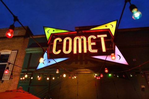 Sign in front of building that reads "COMET" - Comet Ping Pong in Washington, D.C., which was the focal point of the Pizzagate conspiracy theory