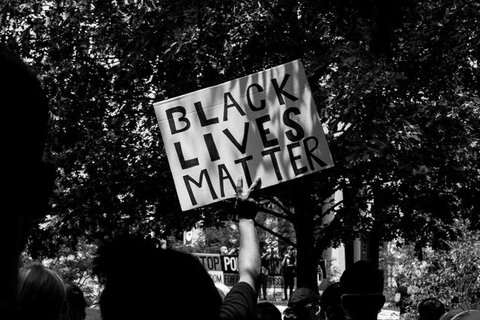 A protester holding a sign that says Black Lives Matter