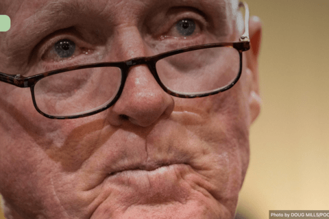 A close up image of a white man with glasses