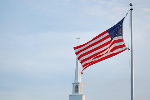 An American flag flying over a chapel.