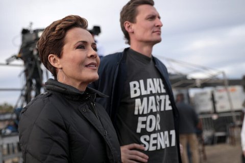 Kari Lake, a white woman with brown short hair looking into the distance.