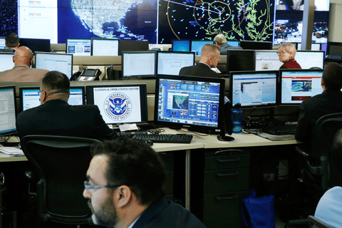 Men sitting in front of computer screens