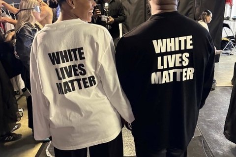 A black woman and a black man wearing a black and white t shirt that says White Lives Matter