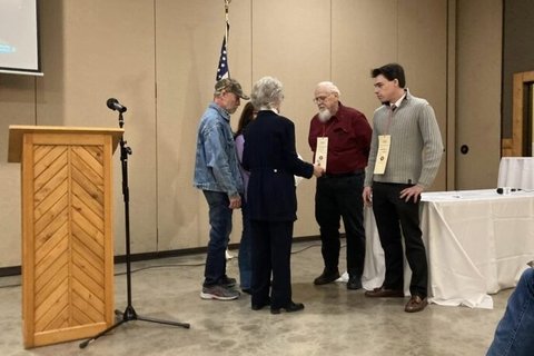 Men shaking hands at a podium