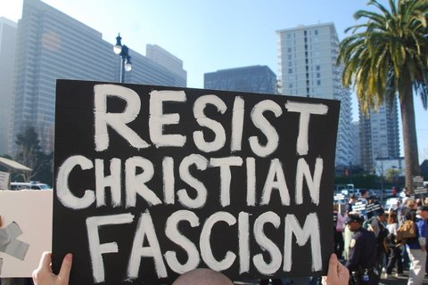 A protest sign that says "Resist Christian Fascism"