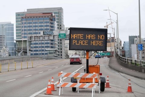 A road sign that says "Hate has no place here"