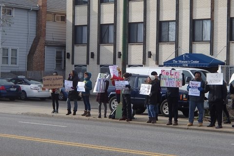 A group of people in Chicago holding protest signs