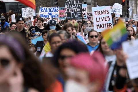 a group of people at a protest for LGBTQ rights