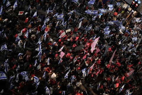A group of people holding Israeli flags.