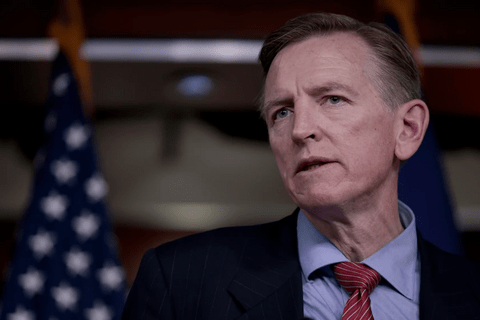 An image of a white man in a blue suit.