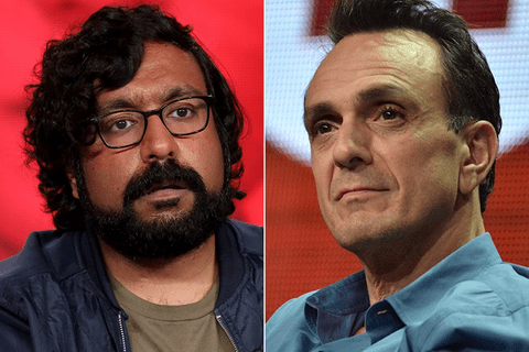 a brown man with curly hair and glasses and a white man in a blue shirt.