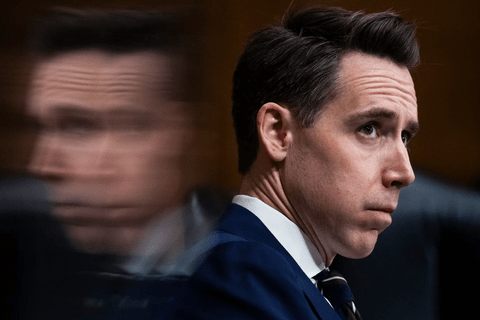 A man in a blue suit looking at something in the distance