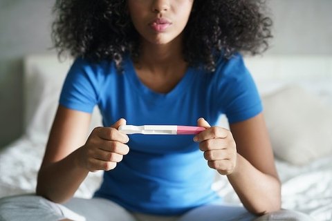 a person holding a pregnancy test