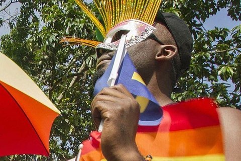 A person wearing an eye mask holding a flag.