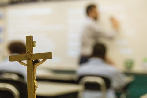 A classroom with a wooden cross