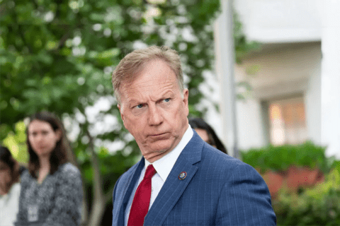 A white man with blonde hair wearing a suit.