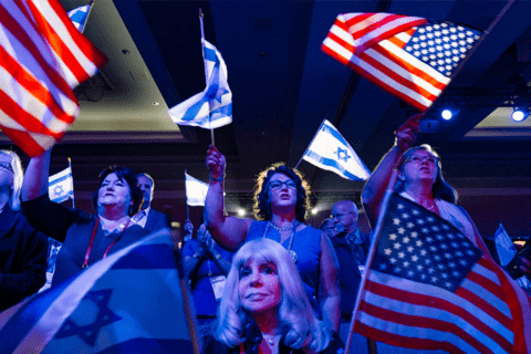 People holding up American and Israeli flags.
