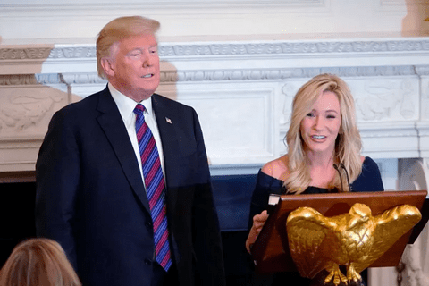 President Trump with his pastor Paula White speaking into a mic