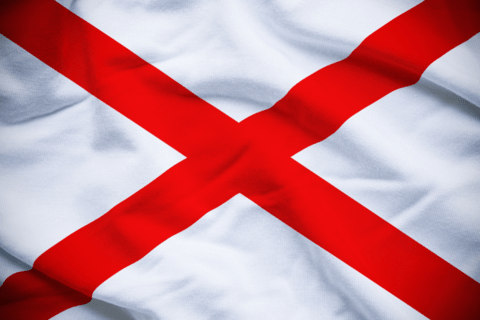 A white flag with a red cross across it. 