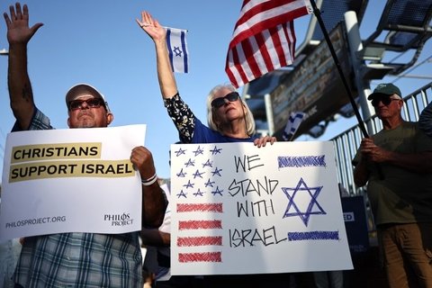 Two people holding signs in support of Israel