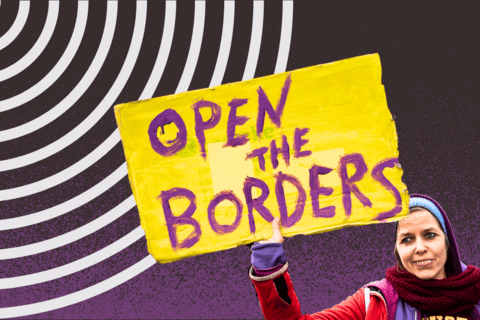 A woman holding a sign that says Open the Borders