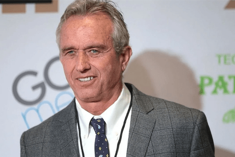 a man in a grey suit and blue tie