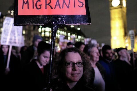 Protestor holds a sign that says "I stand with immigrants"
